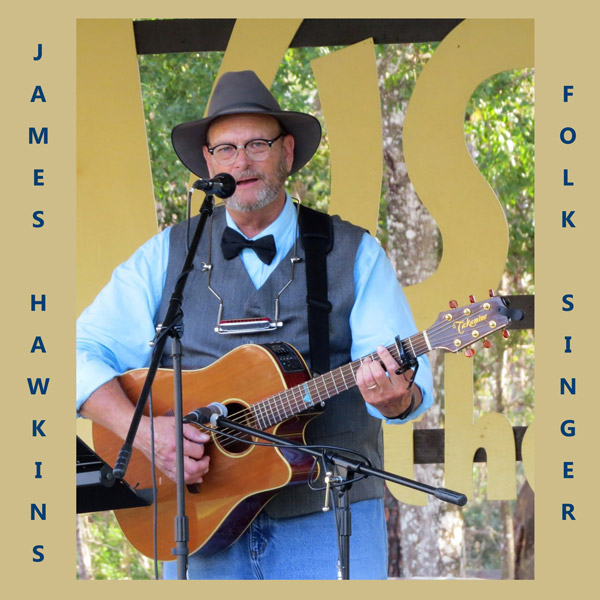 James Hawkins (folk singer) playing guitar and signing into mic